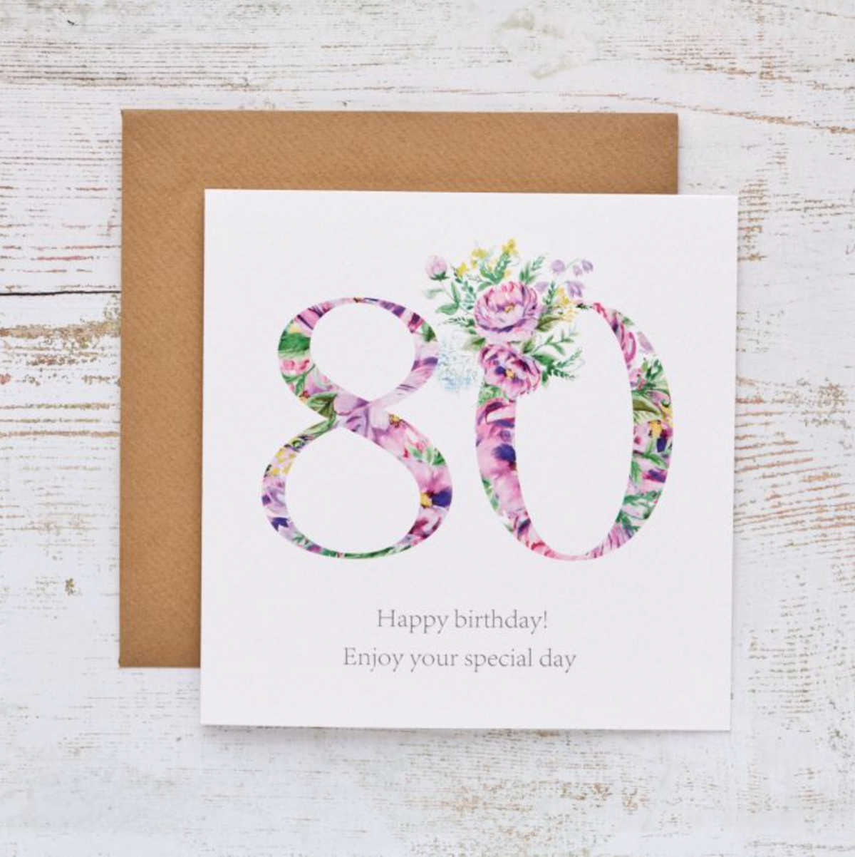 80 Floral Birthday Card with a large 80 filled with purple and pink flowers, with a kraft envelope