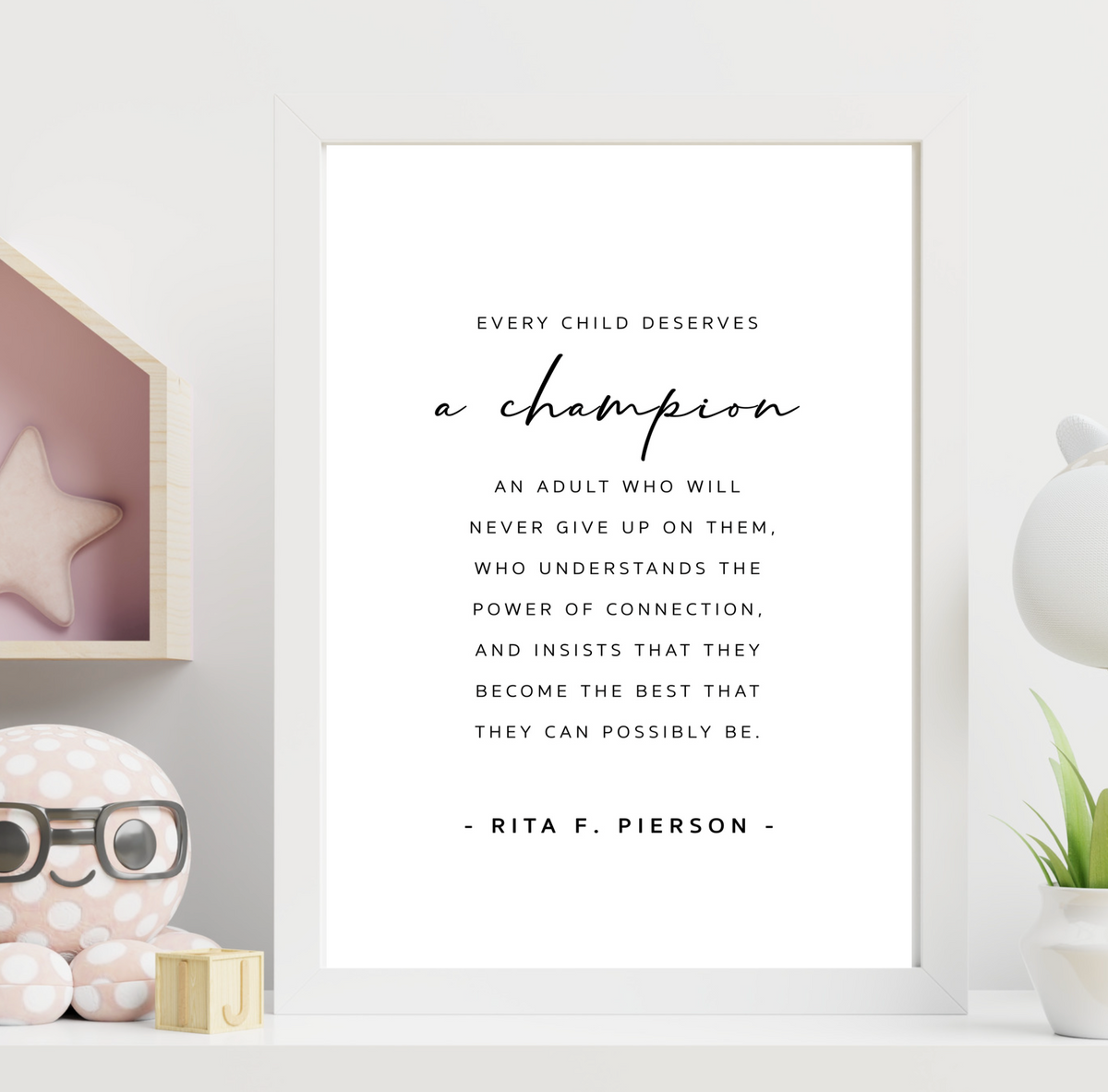 A Champion - Teacher print in a white frame in a child's room beside a toy house shelf