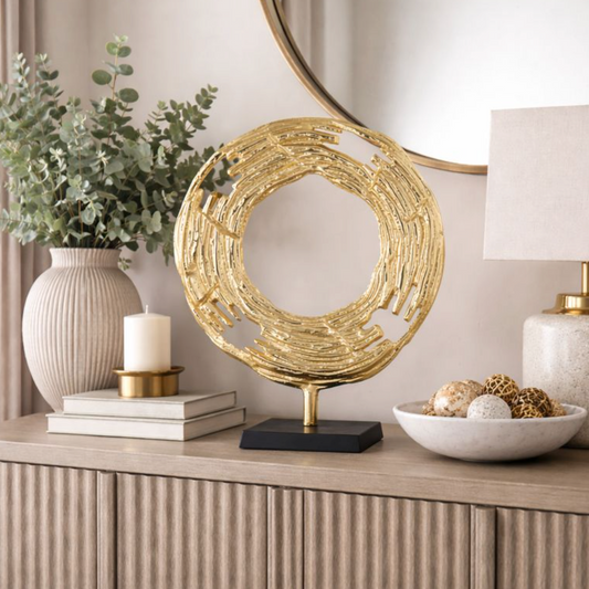 Aurelia Halo Gold Metal Sculpture, Large on a sideboard with a round mirror and vases