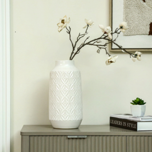 Embossed Ceramic Vase with Geometric Pattern, Medium, with white blossom on a grey sideboard by books