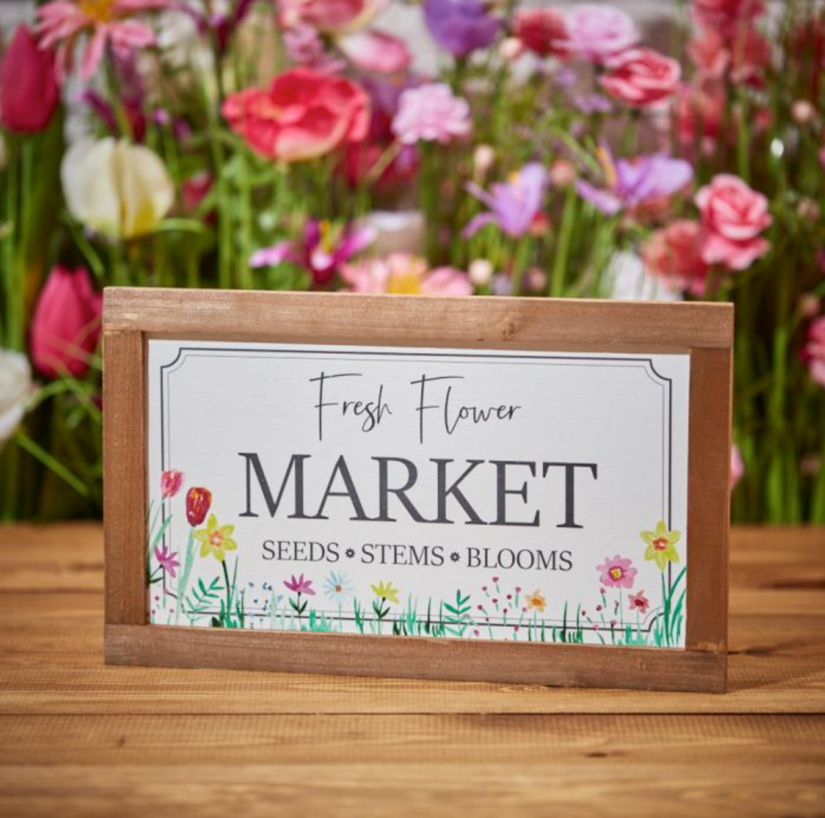 Flower Market Framed Plaque reading Fresh Flower Market, in a wooden frame in front of pink wild flowers