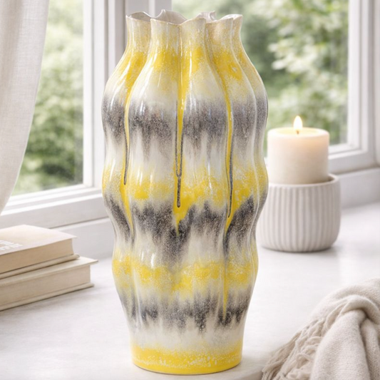 Reactive Glaze Sculptural Ceramic Vase, close view of the rippled yellow and grey drip glaze by a window