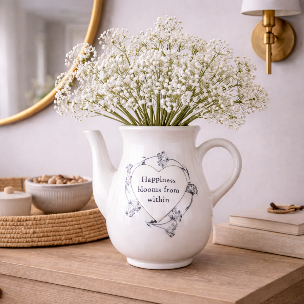 Sentiment Teapot Vase in white ceramic with a printed verse, filled with gypsophila on a side table