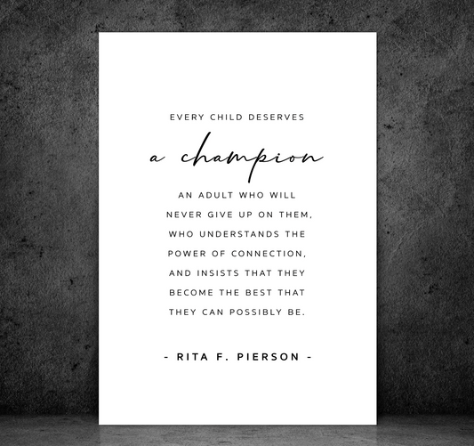 A Champion - Teacher print, the Rita F. Pierson quote on white, shown unframed against a dark concrete wall