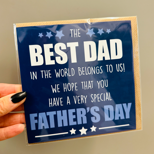 Best Dad Blue Fathers Day card with white lettering on navy and stars, held in a hand