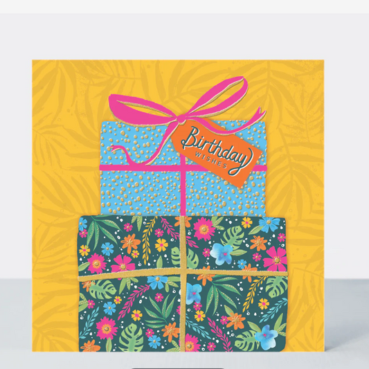 Birthday Presents Card with a stack of patterned gift boxes and a pink bow on a bright yellow background