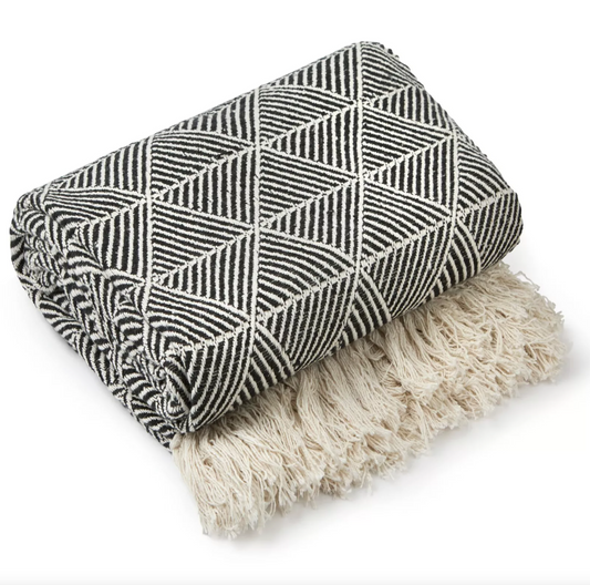 Black Zahra Design Throw folded on a white background, showing the geometric weave and tasselled edge