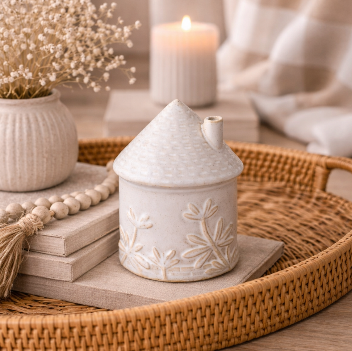 Ceramic House Ornament with Floral Detail, small white house on a rattan tray with candles