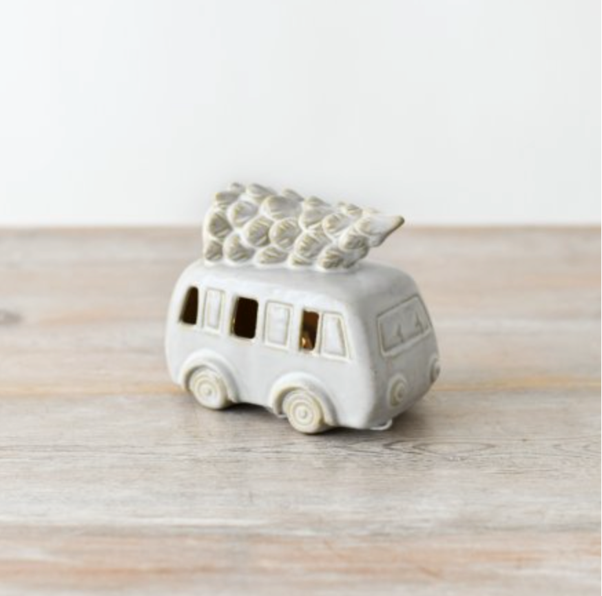 Ceramic LED Camper with Tree, white ceramic camper van with a tree on the roof, on a plain wooden surface