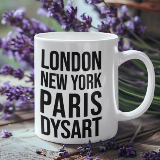 Dysart Mug, a white mug with bold black London New York Paris Dysart lettering, among lavender sprigs