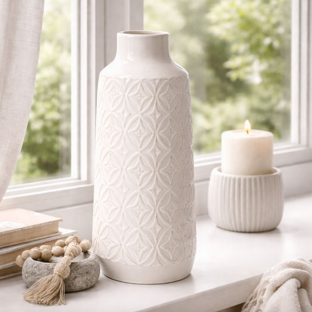 Embossed Ceramic Vase with Geometric Pattern, Large, cream vase on a windowsill beside a ribbed candle