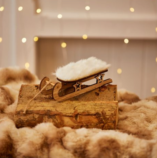 Fluffy Sleigh Hanging Decoration, wooden sleigh with a fluffy white seat on faux fur