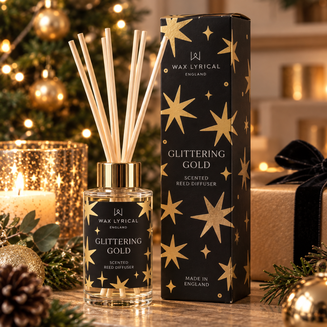 Glittering Gold Reed Diffuser, 100ml, next to its black box with gold stars in a festive setting