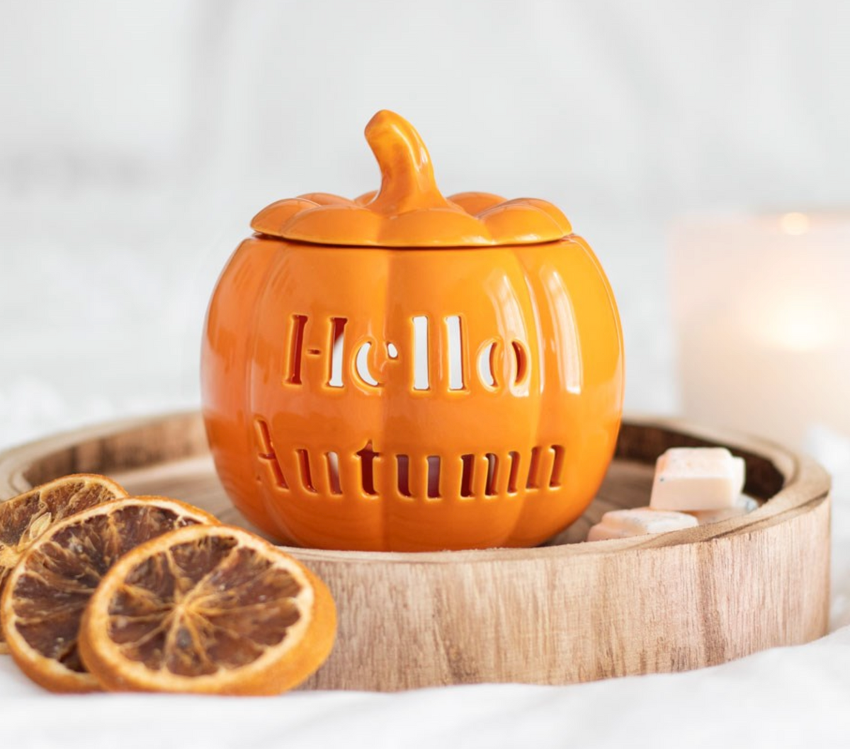 Hello Autumn Pumpkin Wax/Oil Burner in orange ceramic with cut-out lettering, on a tray with orange slices