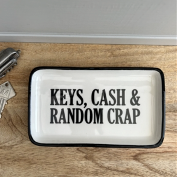 Keys, Cash and Random Crap Tray in white with black lettering, seen from above on wood