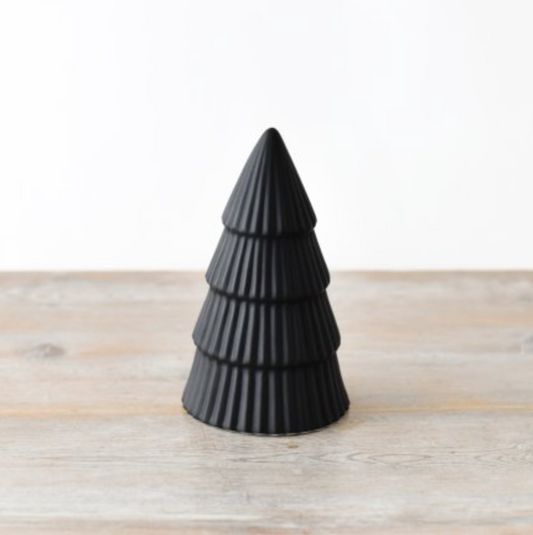 Matt Black Tree Ornament Medium, ridged black ceramic cone tree on a pale wooden surface