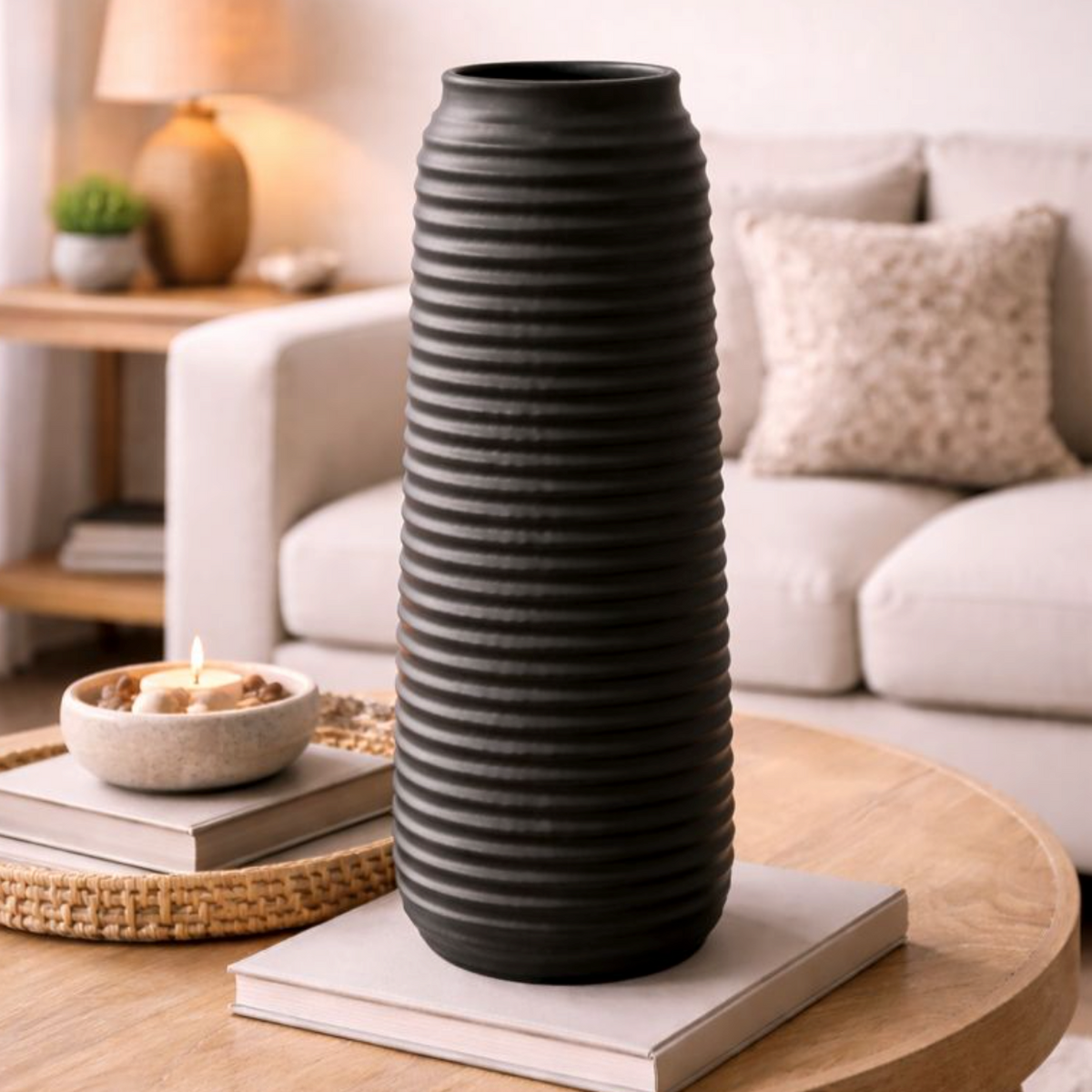 Matte Black Textured Vase 35cm with ribbed rings, on a coffee table in a living room with a cream sofa