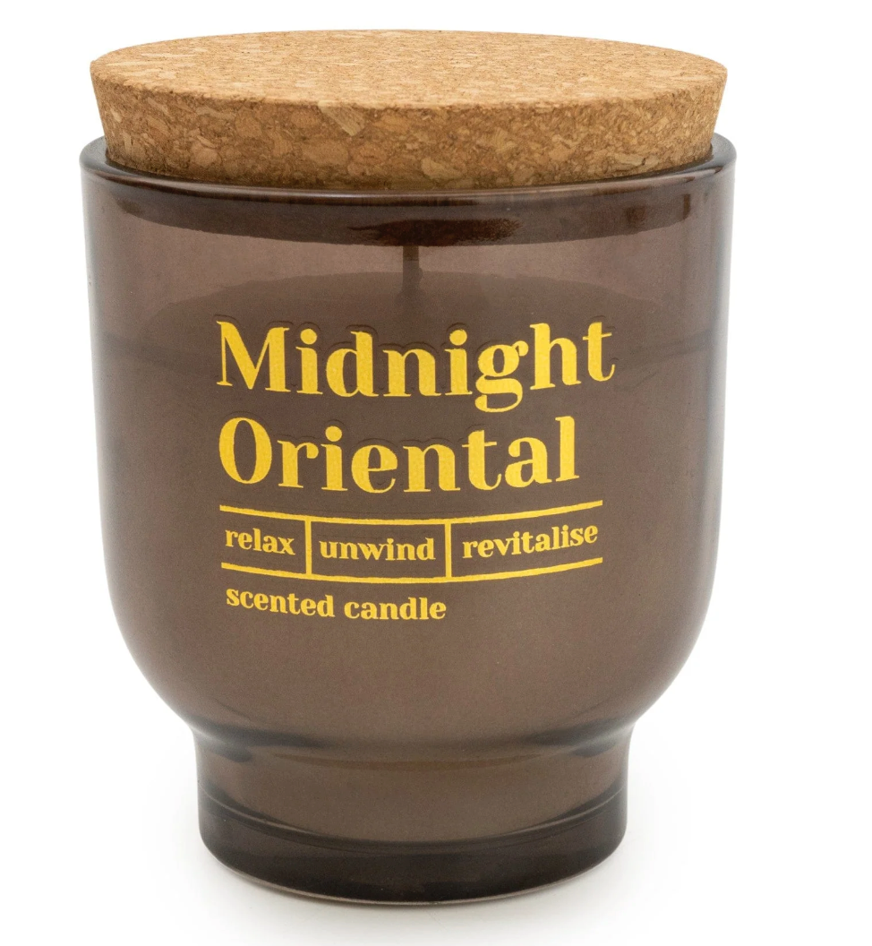 Midnight Oriental Scented Candle in a smoky brown jar with gold lettering and a cork lid, on white