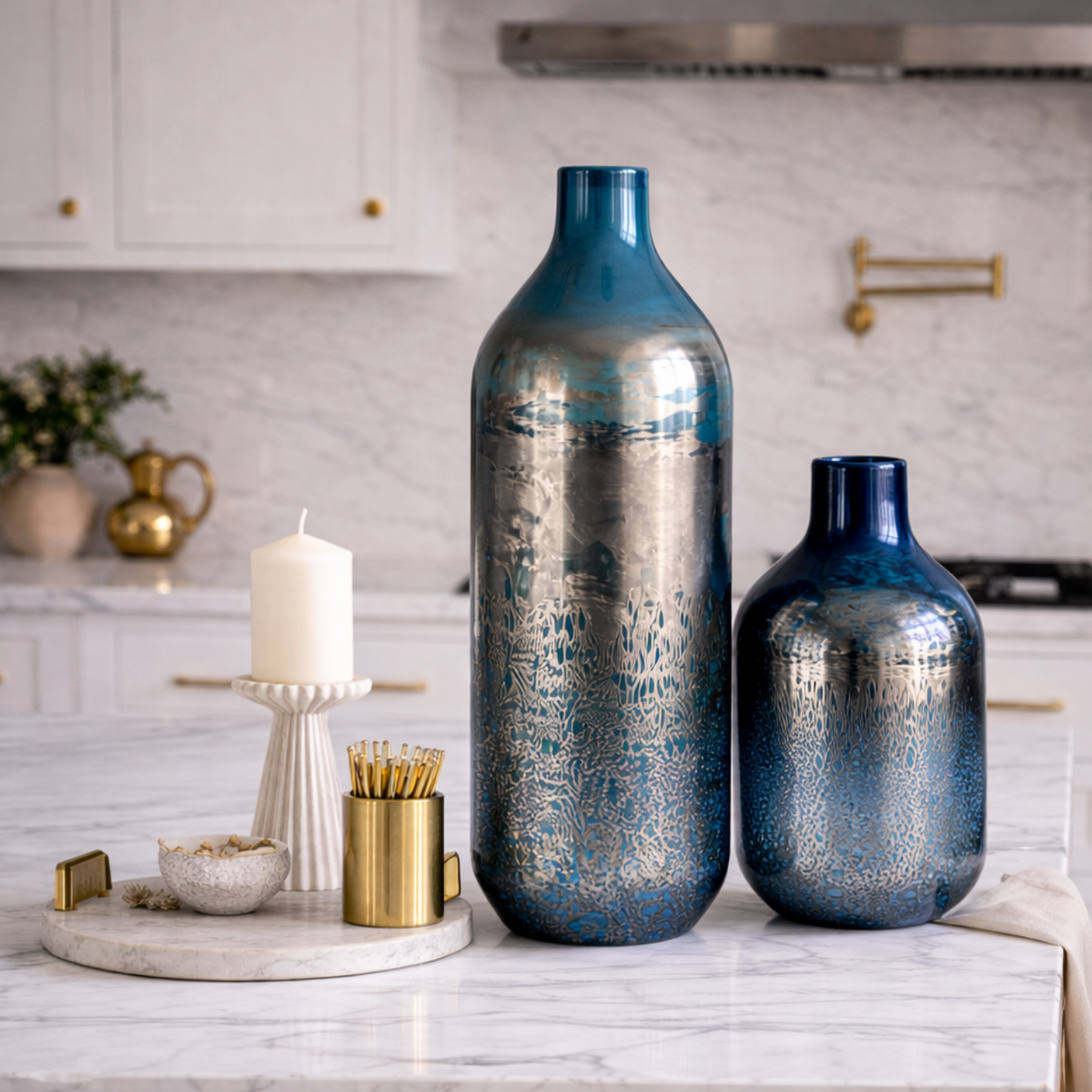 Nocturne Tide Glass Tall Vase beside a smaller matching vase and candles on marble