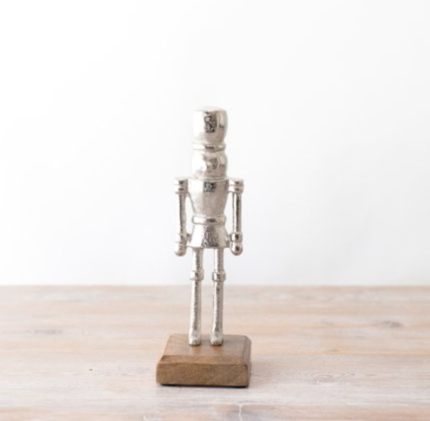 Nutcracker Ornament, silver soldier figure on a natural wooden block base against a plain white background