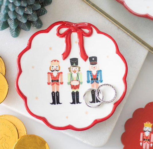 Nutcracker Trinket Dish With Bow, white dish with nutcracker soldiers and red bow on a table