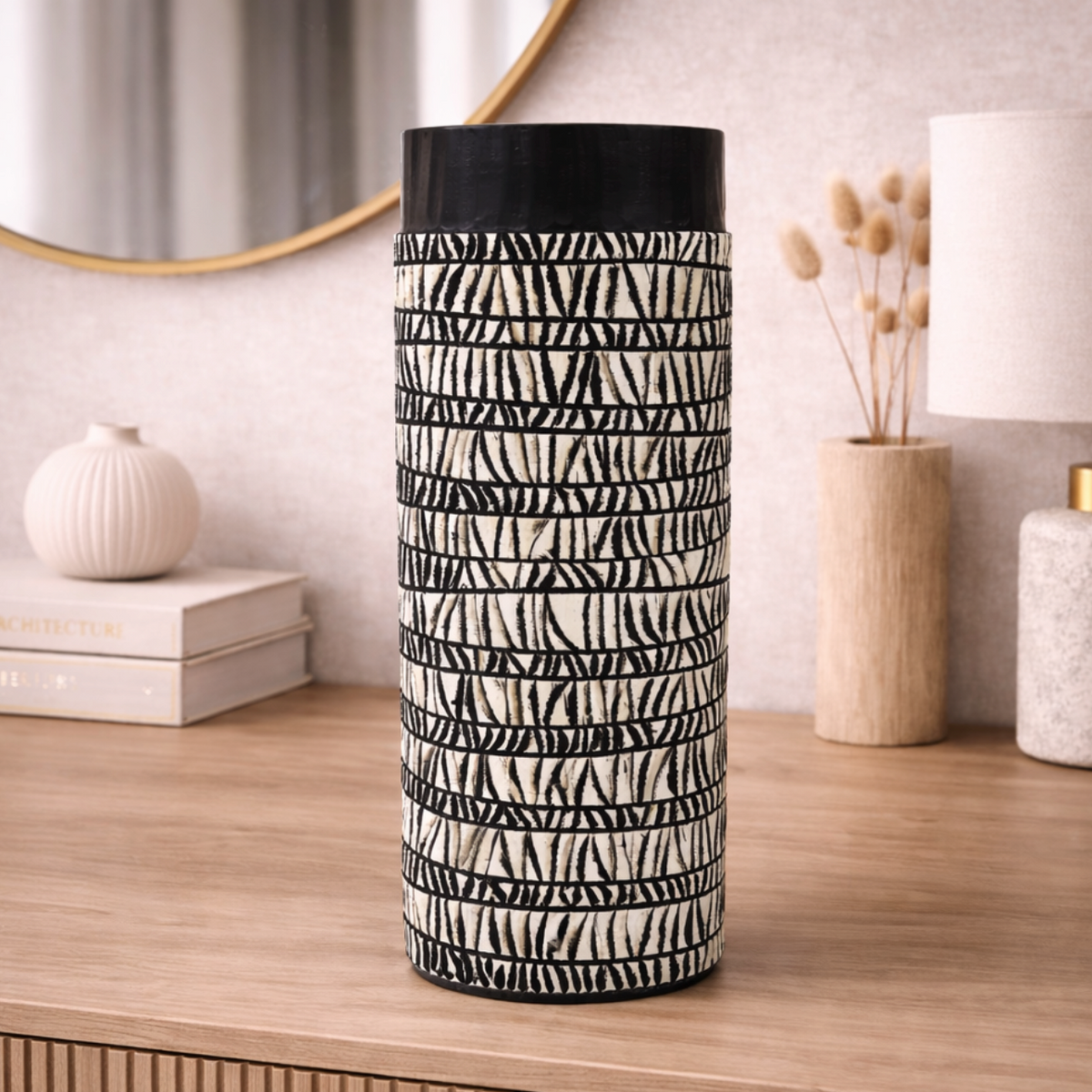 Patterned Oval Vase - Large, black and white line-patterned cylinder on a wooden sideboard