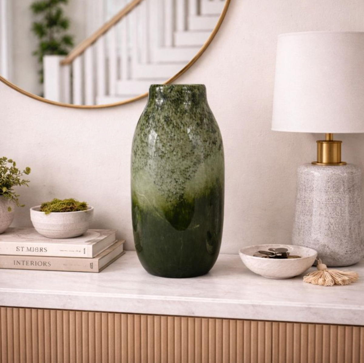 Verde Echo Handmade Glass Vase, Large, dark green glass fading to smoky grey, on a marble console by a lamp