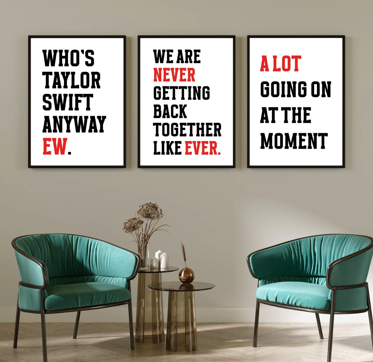 Who Is She Anyway? print hung as a trio of bold black and red typographic prints above two teal chairs
